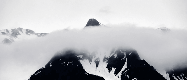 A serene collection of mountain wall art featuring tranquil alpine scenes, snowy ridges, and misty valley photography.