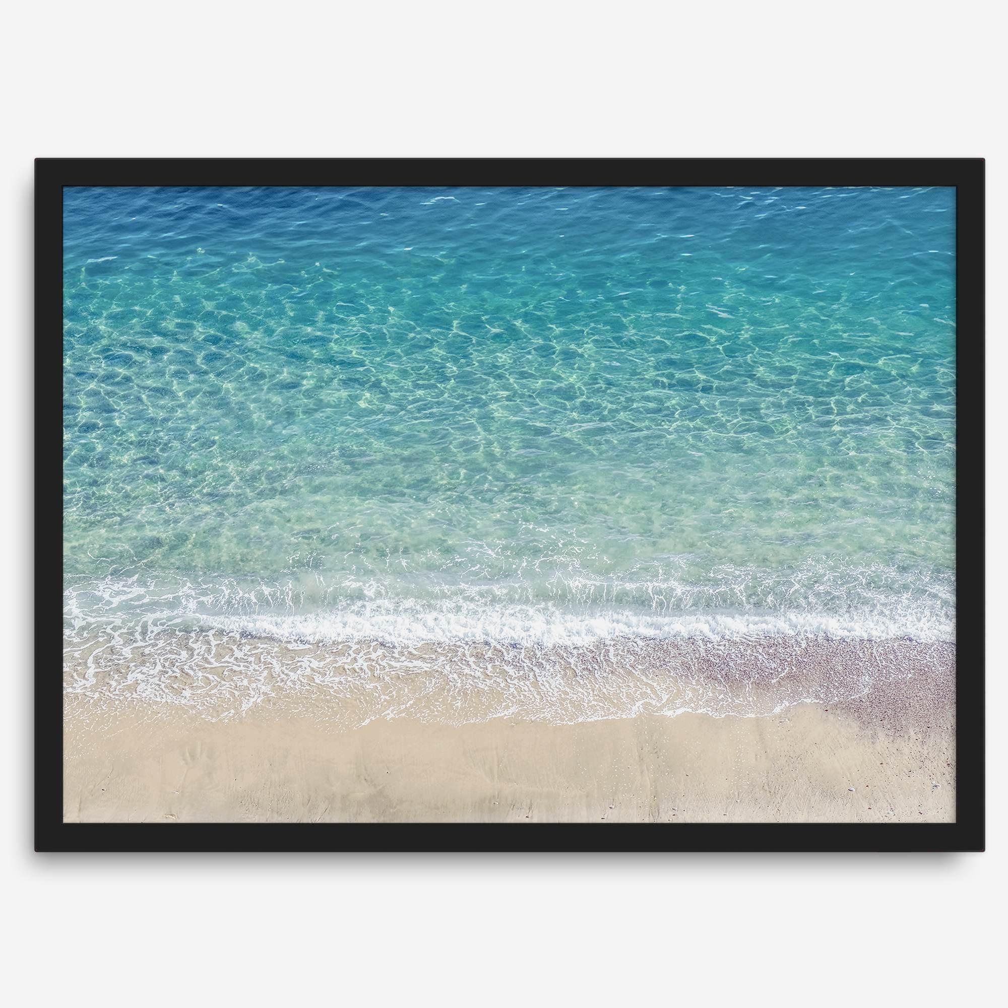 This fine art aerial beach print showcases the mesmerizing colors of the ocean in vivid detail. From the deep blue depths to the vibrant greenish turquoise blue, transitioning to the golden sandy beach and the crashing white surf.