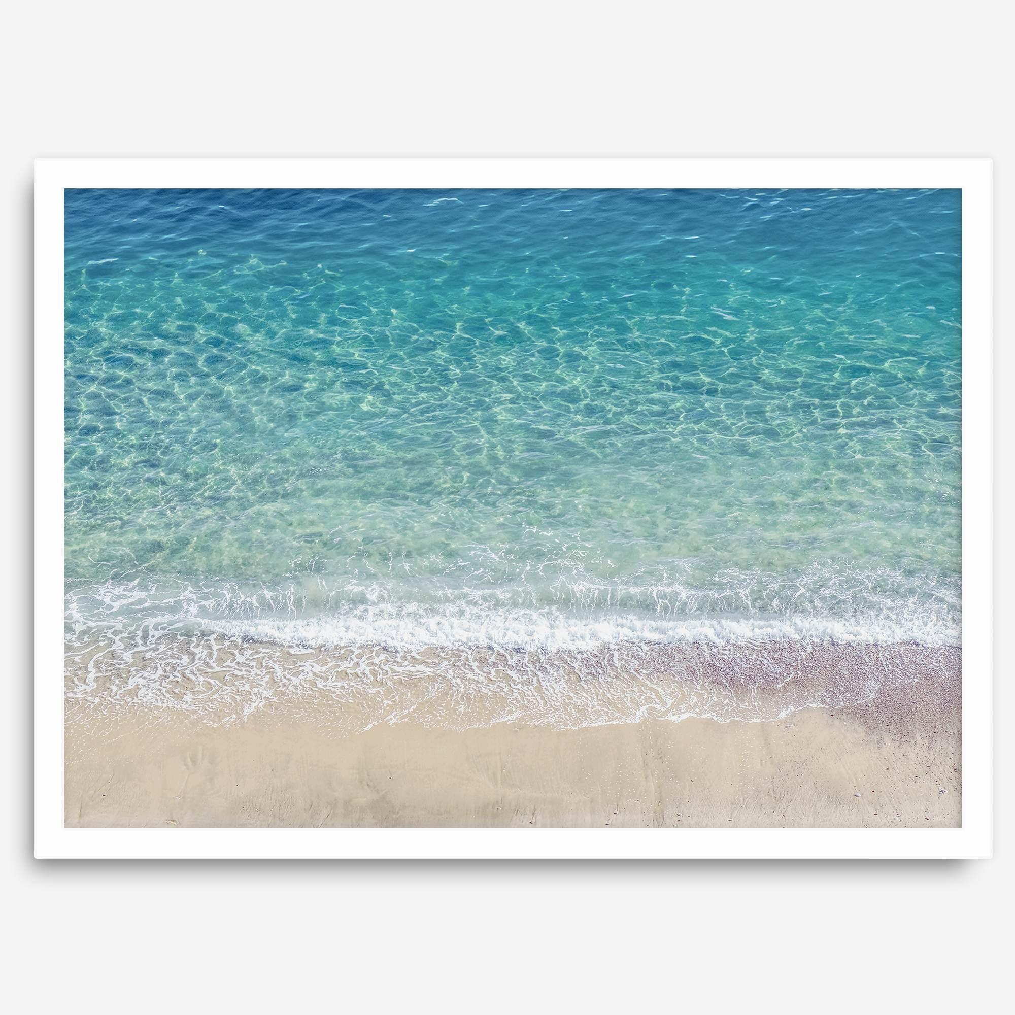 This fine art aerial beach print showcases the mesmerizing colors of the ocean in vivid detail. From the deep blue depths to the vibrant greenish turquoise blue, transitioning to the golden sandy beach and the crashing white surf.