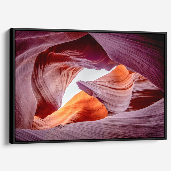 Vivid Antelope Canyon canvas featuring glowing sandstone curves in warm orange, red, and purple hues with sunlight streaming through.