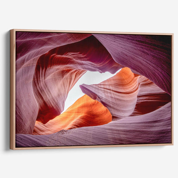 Vivid Antelope Canyon canvas featuring glowing sandstone curves in warm orange, red, and purple hues with sunlight streaming through.