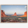 A fine art landscape photography print of a desert sunset over Monument Valley, located on the Arizona-Utah border. The warm and vibrant hues of this American Southwest sunset create a mesmerizing and awe-inspiring scene.