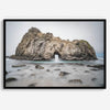 Fine art print showcasing a magnificent rock formation framing the horizon and crashing waves, with scattered rocks adding texture. Captivating and soothing, this print is a timeless addition to any space, evoking relaxation and awe-inspiring beauty.