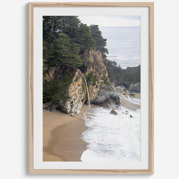 This captivating California coastal beach print captures the awe-inspiring scene of McWay Falls in Big Sur, as its creamy waterfall cascades onto a pristine beach and merges with the rhythmic dance of the ocean waves.