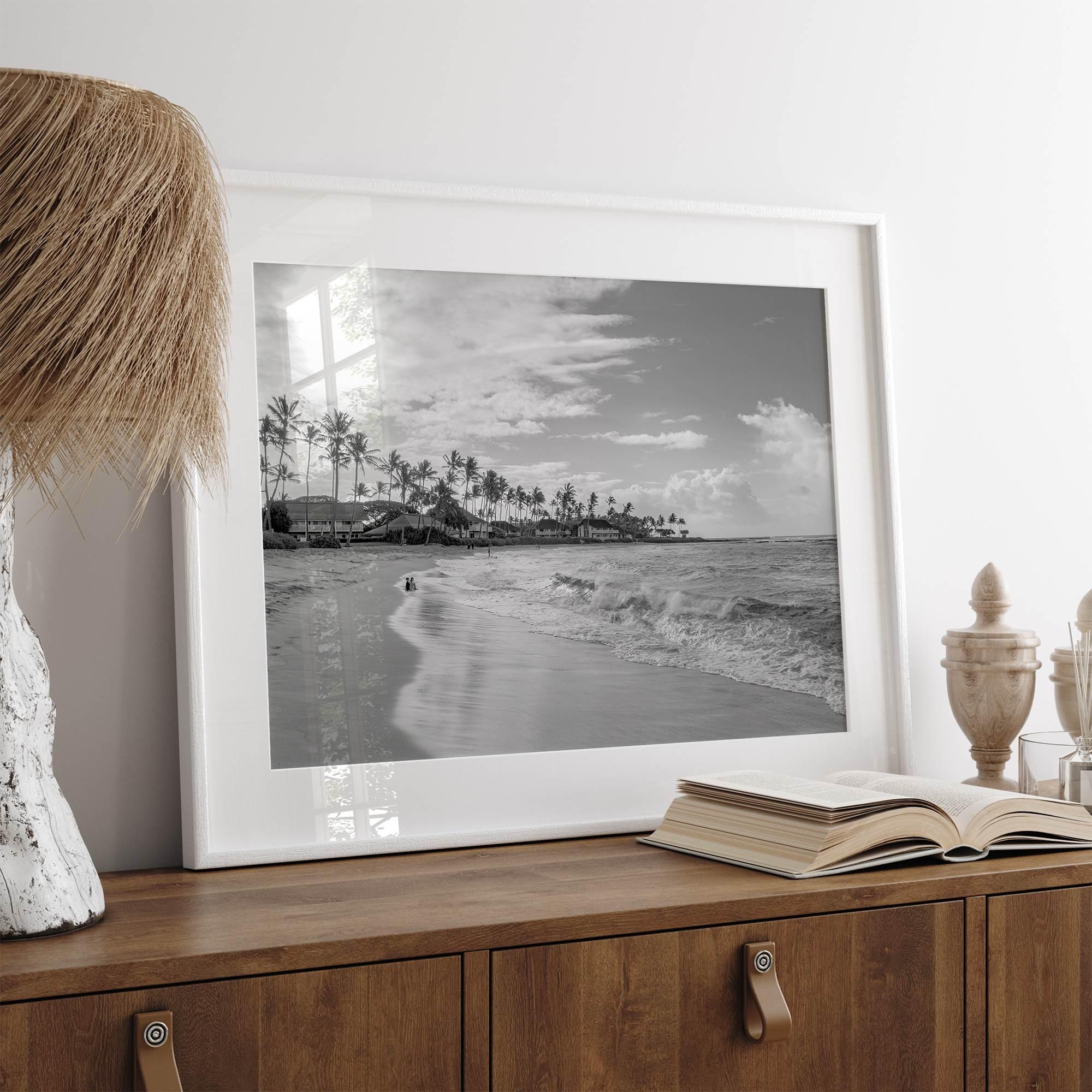 Black and white tropical wall art featuring a serene sunrise on a beach in Kauai, Hawaii with palm trees