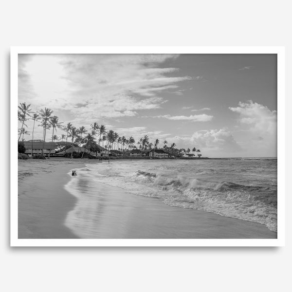 Black and white tropical wall art featuring a serene sunrise on a beach in Kauai, Hawaii with palm trees
