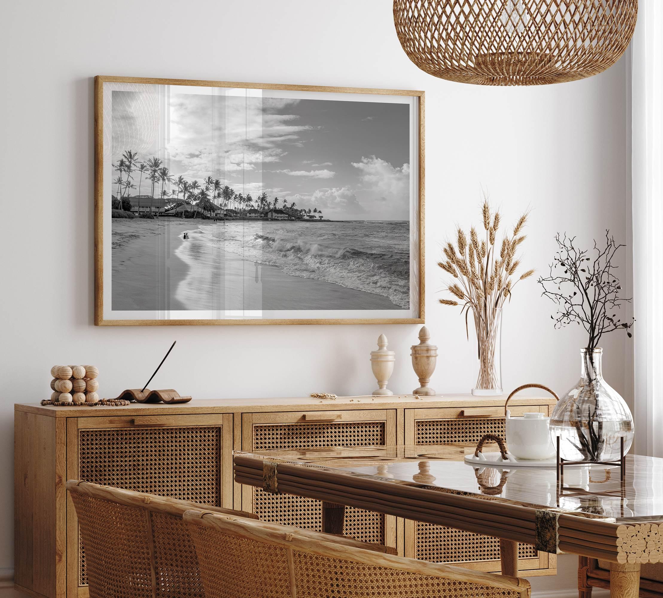 Black and white tropical wall art featuring a serene sunrise on a beach in Kauai, Hawaii with palm trees