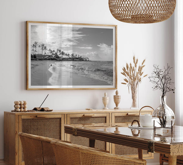 Black and white tropical wall art featuring a serene sunrise on a beach in Kauai, Hawaii with palm trees