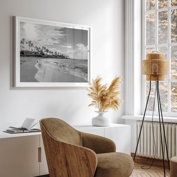 Black and white tropical wall art featuring a serene sunrise on a beach in Kauai, Hawaii with palm trees