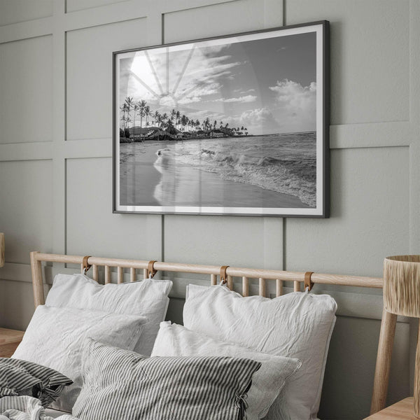 Black and white tropical wall art featuring a serene sunrise on a beach in Kauai, Hawaii with palm trees