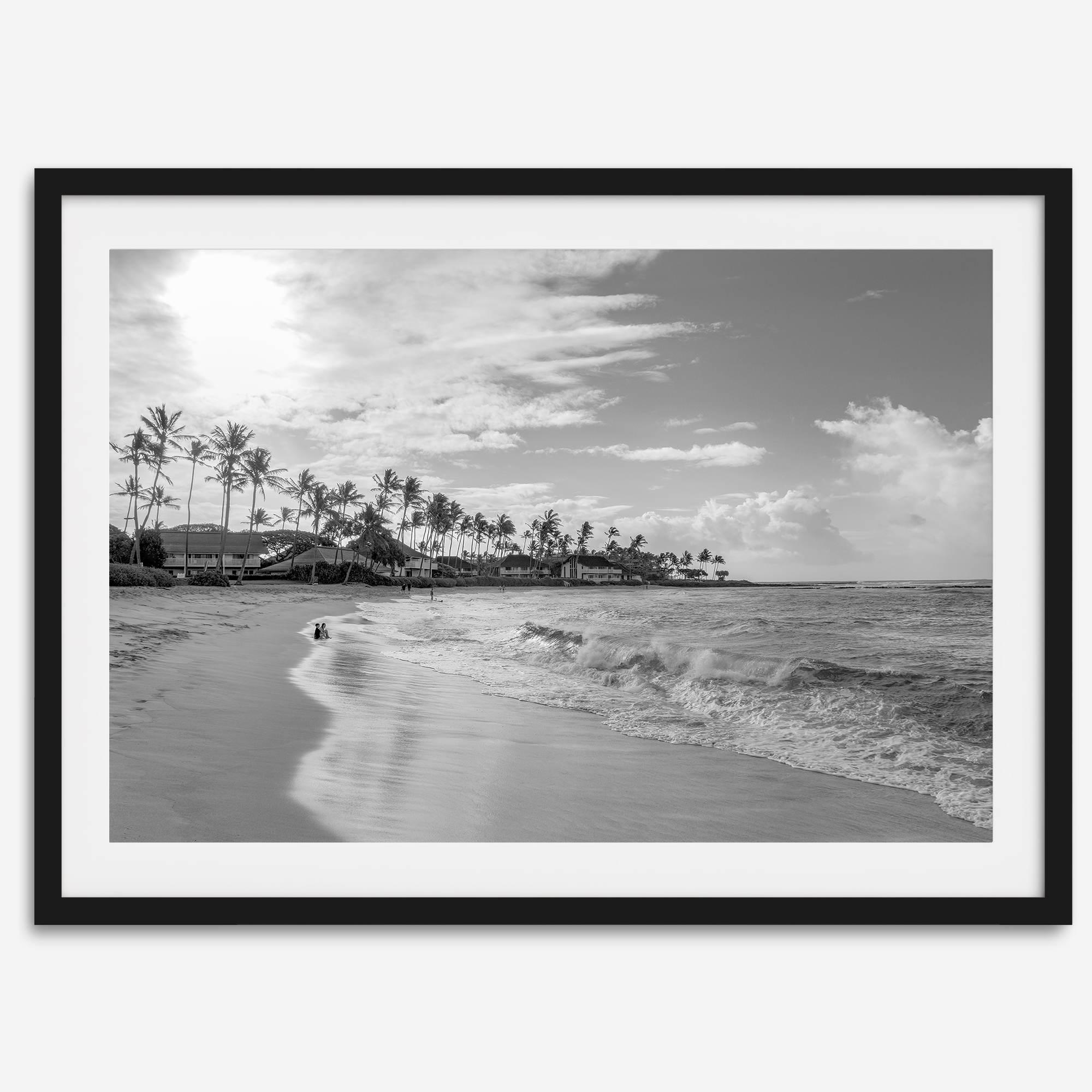 Black and white tropical wall art featuring a serene sunrise on a beach in Kauai, Hawaii with palm trees