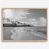 Black and white tropical wall art featuring a serene sunrise on a beach in Kauai, Hawaii with palm trees