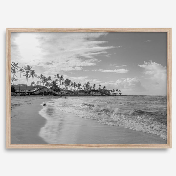 Black and white tropical wall art featuring a serene sunrise on a beach in Kauai, Hawaii with palm trees