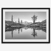 Black and white fine art photo of a serene mountain and forest mirrored in a still lake at sunset.