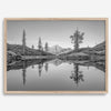 Black and white fine art photo of a serene mountain and forest mirrored in a still lake at sunset.