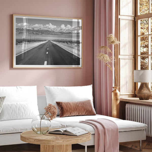 This stunning piece of black and white desert wall art will take your breath away. A beautifully framed picture of a Death Valley National Park road leading towards the snow-covered mountains at the end of the desert.