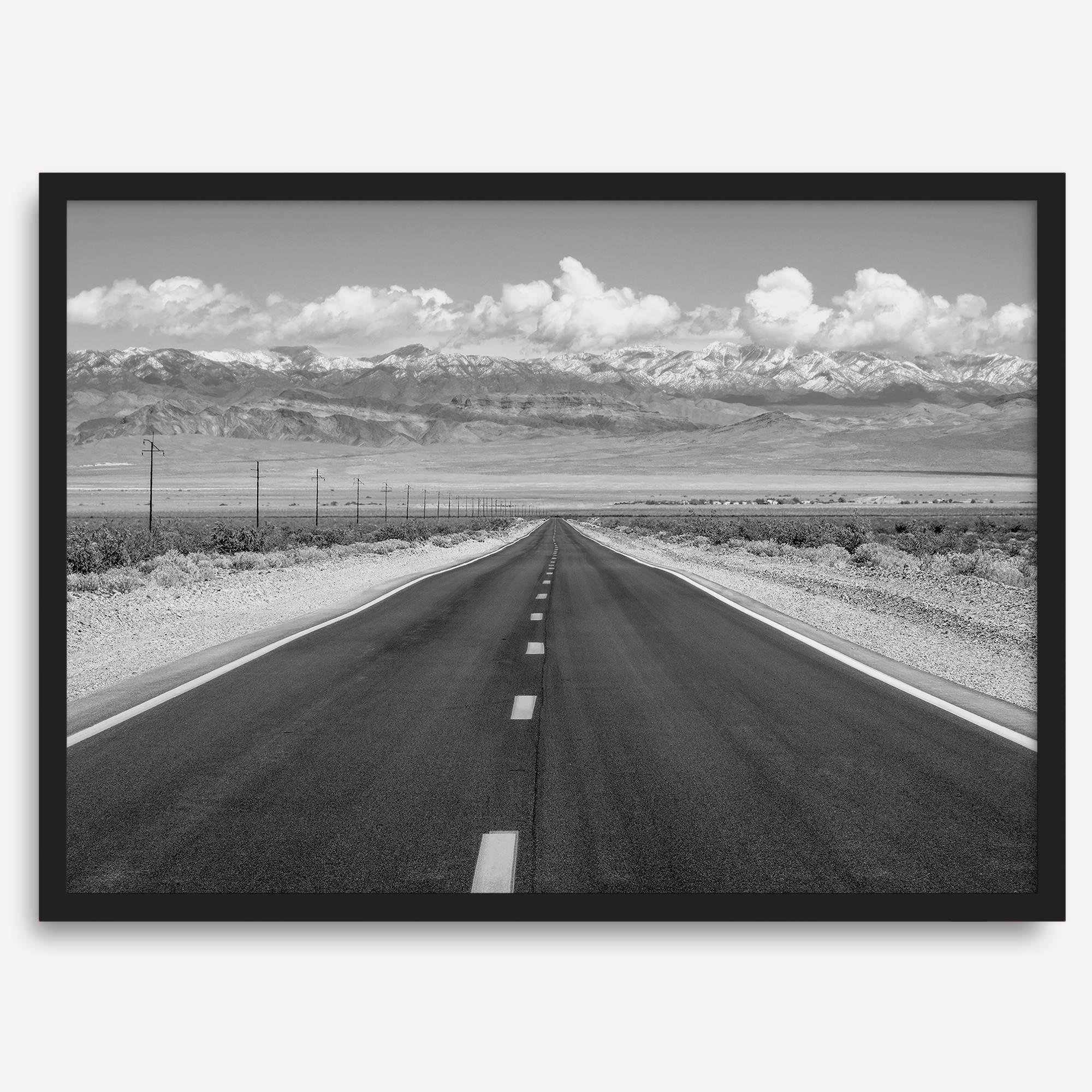 This stunning piece of black and white desert wall art will take your breath away. A beautifully framed picture of a Death Valley National Park road leading towards the snow-covered mountains at the end of the desert.