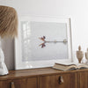 A fine art minimalist wildlife photography print showcasing a bird flying over a lake in Arizona.