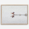 A fine art minimalist wildlife photography print showcasing a bird flying over a lake in Arizona.