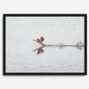 A fine art minimalist wildlife photography print showcasing a bird flying over a lake in Arizona.