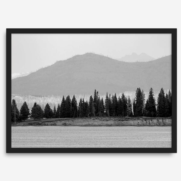 Abstract nature art of a forested island on Yellowstone Lake with black-and-white photography and misty mountains.