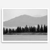 Abstract nature art of a forested island on Yellowstone Lake with black-and-white photography and misty mountains.