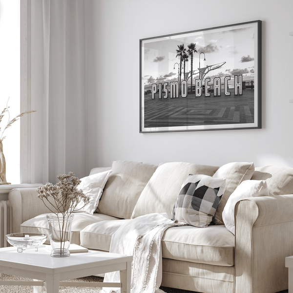 Black and white photo of the Pismo Beach street sign with palm trees and boardwalk – fine art coastal print