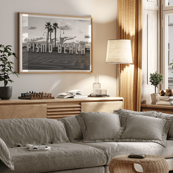 Black and white photo of the Pismo Beach street sign with palm trees and boardwalk – fine art coastal print