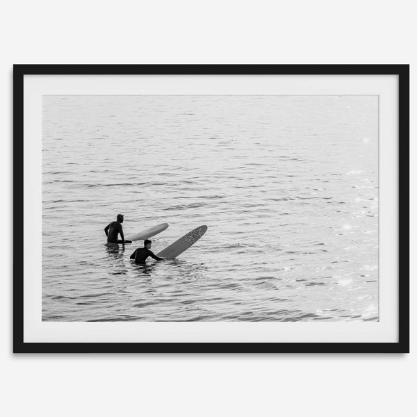 Black and white photo of two surfers with longboards waiting in calm ocean water – fine art surf photography print