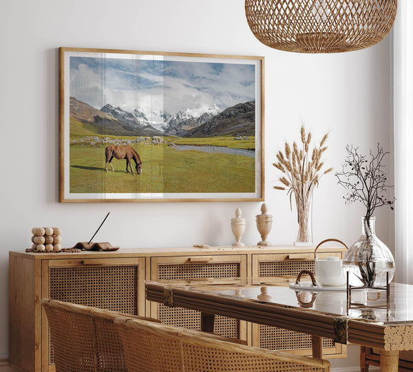 This stunning piece of mountain Horse wall art was taken in Peru and showcases beautiful snow-covered mountains and grassy meadows in Peru and a charming horse grazing relaxingly in the forefront of the picture.