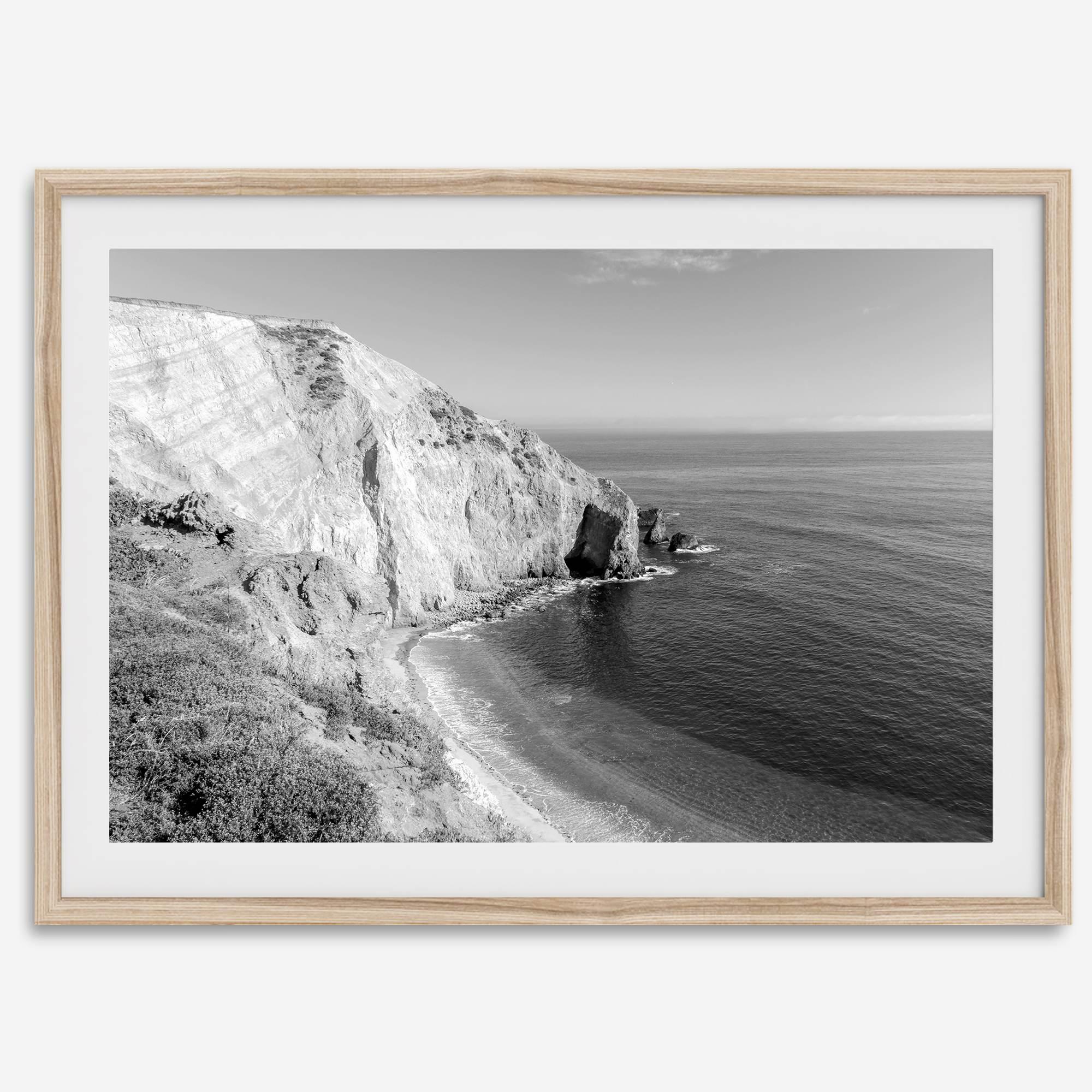 A black and white fine art ocean wall art print of a coastal cliff and beautiful beach in Chimney Rock trail, Point Reyes, California.