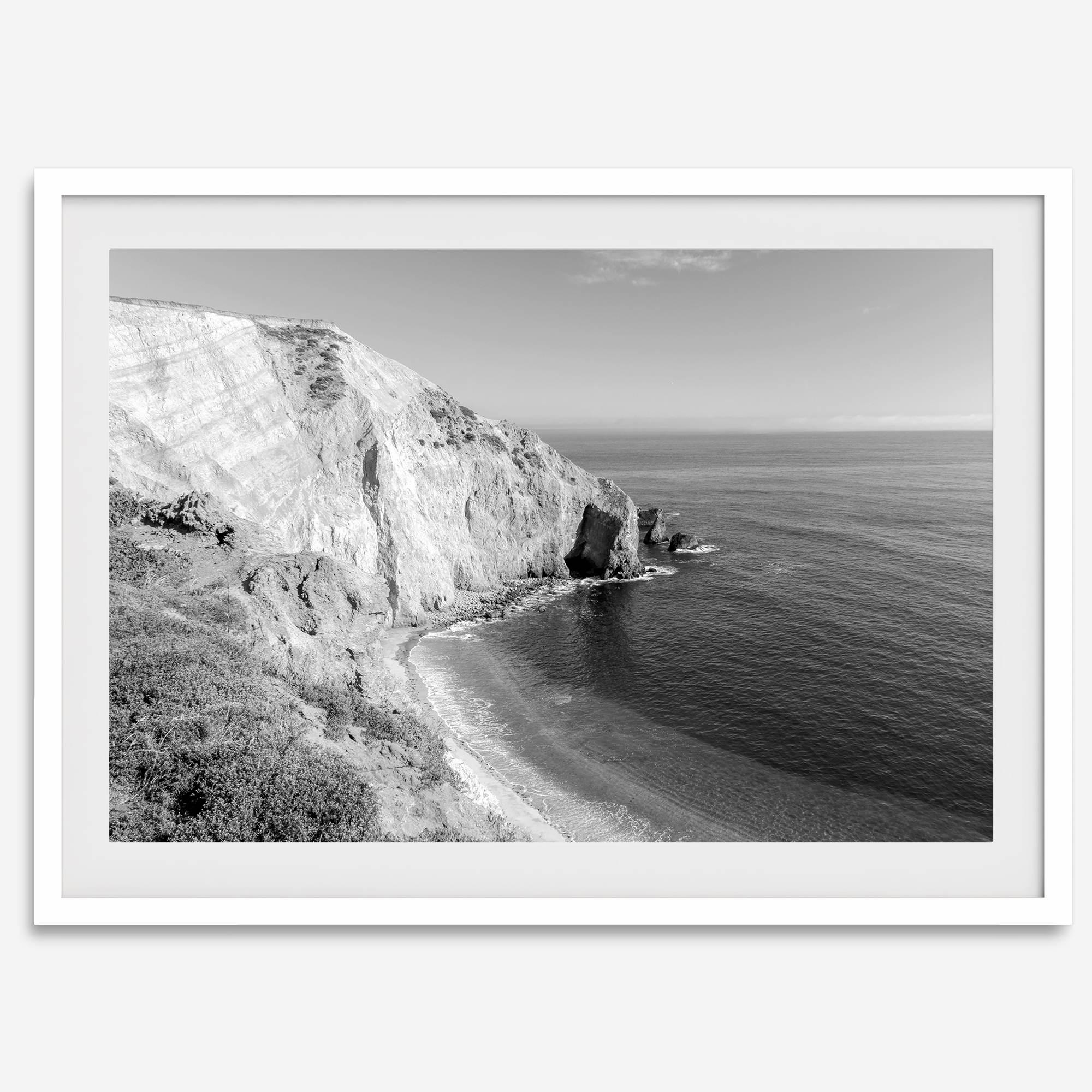 A black and white fine art ocean wall art print of a coastal cliff and beautiful beach in Chimney Rock trail, Point Reyes, California.