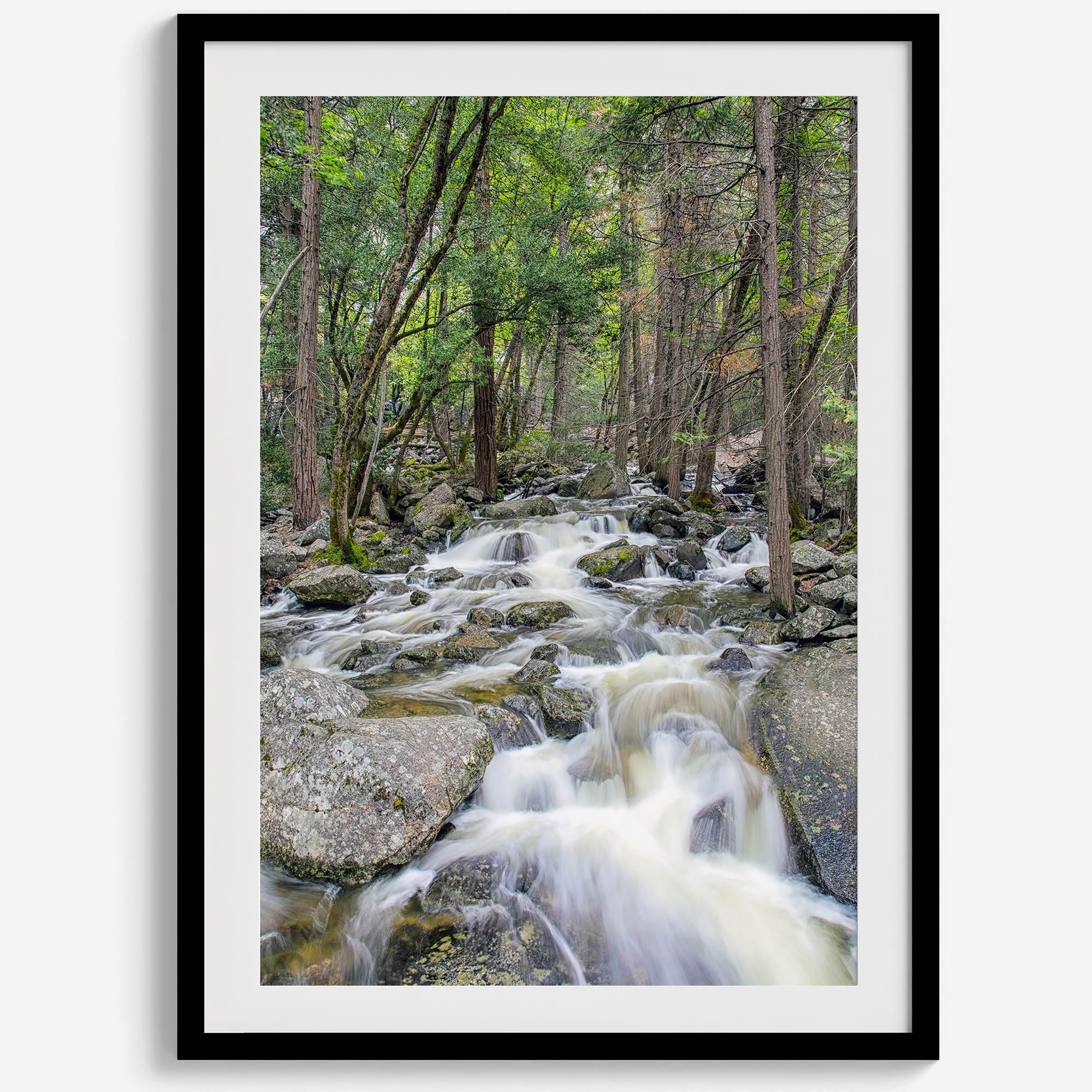 A beautiful river cuts through the forest, shot in long exposure making the water look creamy and calm in this fine art Yosemite National Park print.