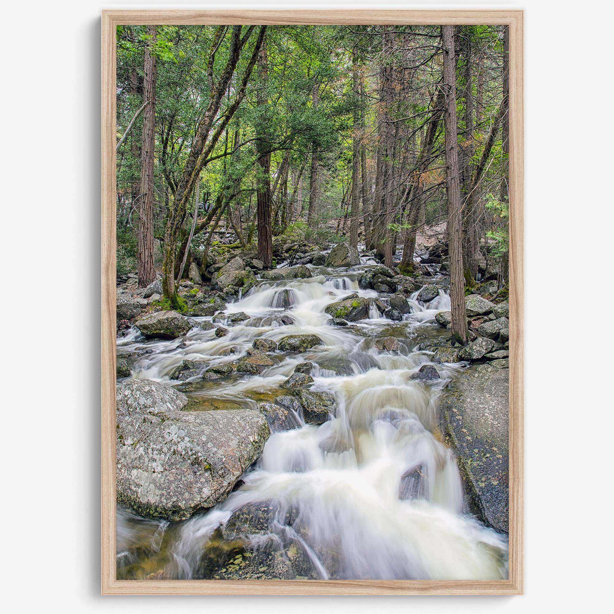 A beautiful river cuts through the forest, shot in long exposure making the water look creamy and calm in this fine art Yosemite National Park print.