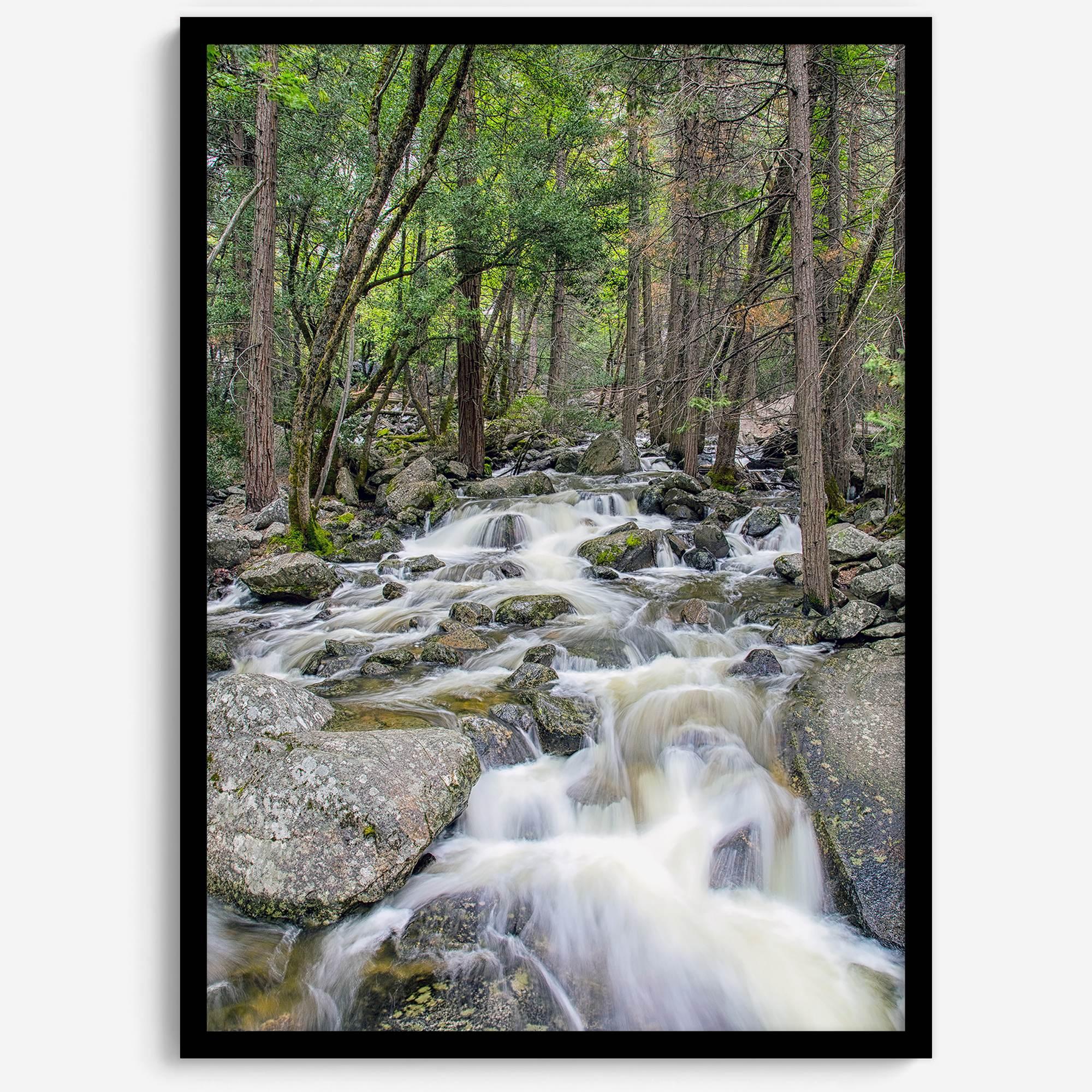 A beautiful river cuts through the forest, shot in long exposure making the water look creamy and calm in this fine art Yosemite National Park print.