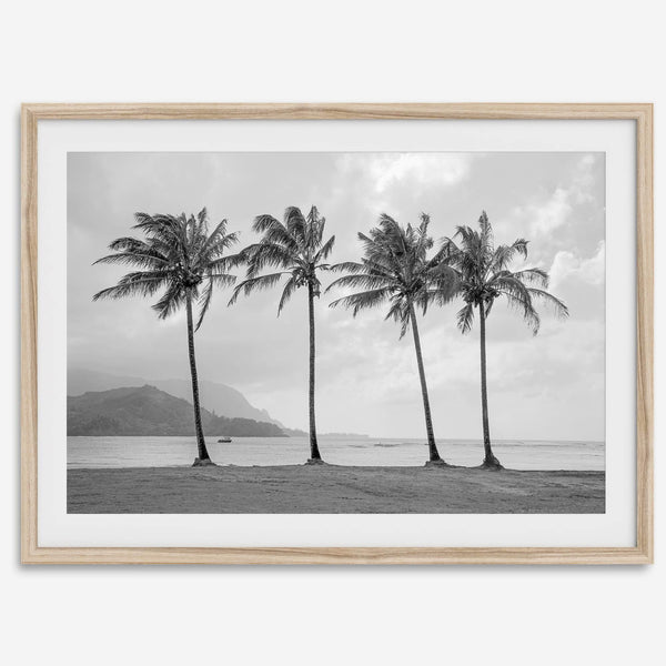 Black and white Hanalei Beach wall art featuring four palm trees with a coastal Kauai backdrop.