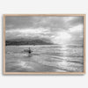 Surfer Wall Art featuring a lone surfer emerging from the ocean at Hanalei Bay in black-and-white photography.