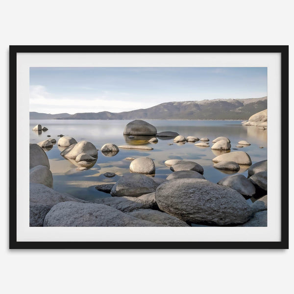 This breathtaking fine art Lake Tahoe print captures the perfect shape of the huge rocks that rise from the crystal-clear water, creating a beautiful contrast against the blue sky and the distant mountain range.