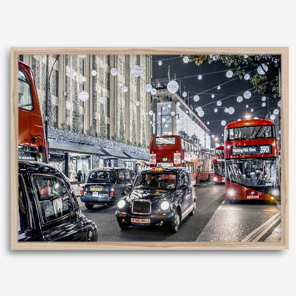 Fine art photography print of a bustling London street during Christmas, featuring double-decker buses, black taxis, and festive holiday lights.