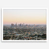 Los Angeles cityscape bathed in a vibrant sunset, showcasing the city's iconic buildings from above