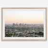 Los Angeles cityscape bathed in a vibrant sunset, showcasing the city's iconic buildings from above