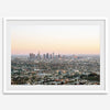 Los Angeles cityscape bathed in a vibrant sunset, showcasing the city's iconic buildings from above