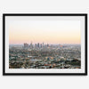 Los Angeles cityscape bathed in a vibrant sunset, showcasing the city's iconic buildings from above