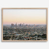 Los Angeles cityscape bathed in a vibrant sunset, showcasing the city's iconic buildings from above