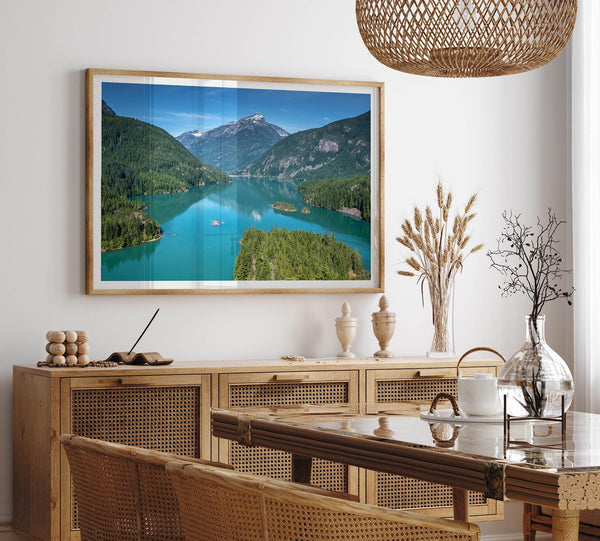 A fine art poster print of Diablo Lake in North Cascades National Park showcasing the deep blue water and the reflection of the surrounding mountains.
