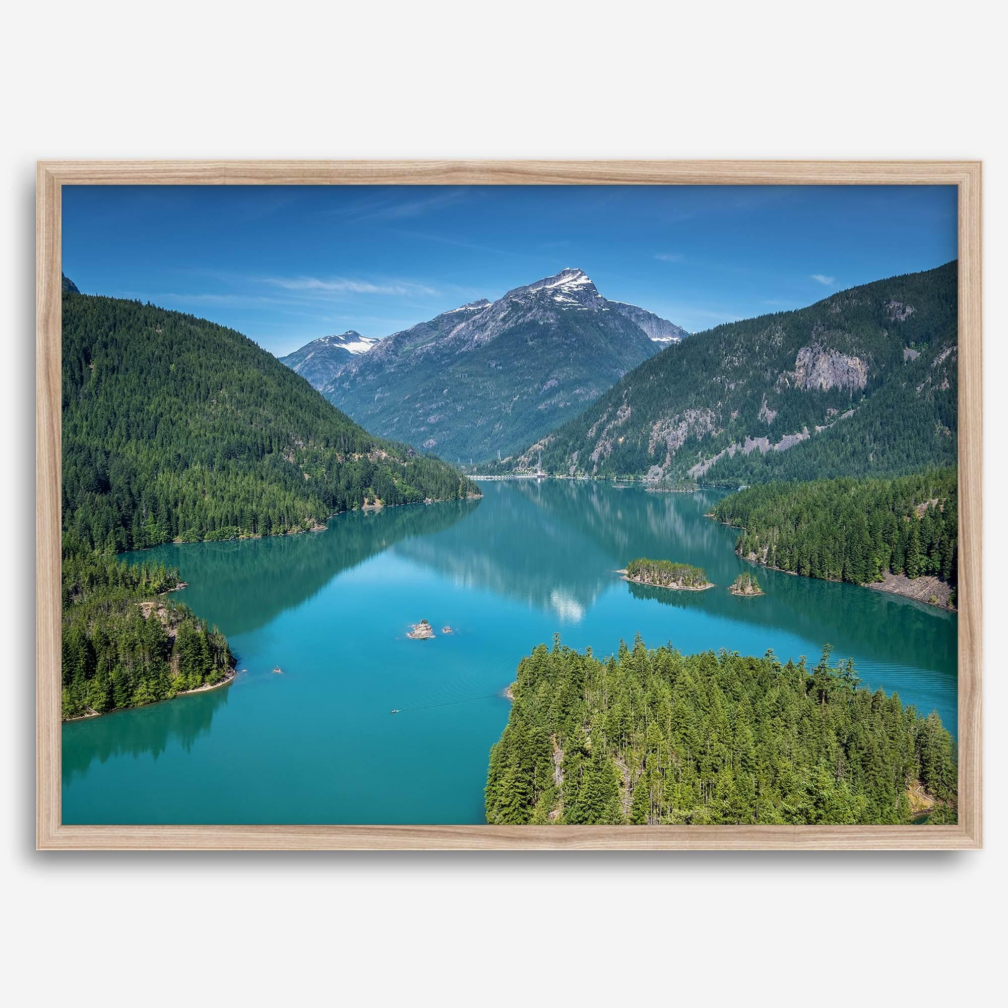 A fine art poster print of Diablo Lake in North Cascades National Park showcasing the deep blue water and the reflection of the surrounding mountains.