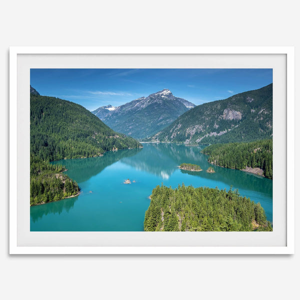 A fine art poster print of Diablo Lake in North Cascades National Park showcasing the deep blue water and the reflection of the surrounding mountains.