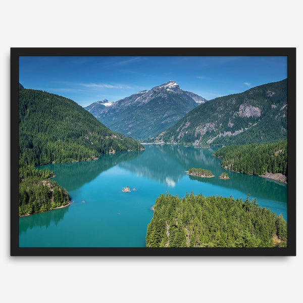 A fine art poster print of Diablo Lake in North Cascades National Park showcasing the deep blue water and the reflection of the surrounding mountains.