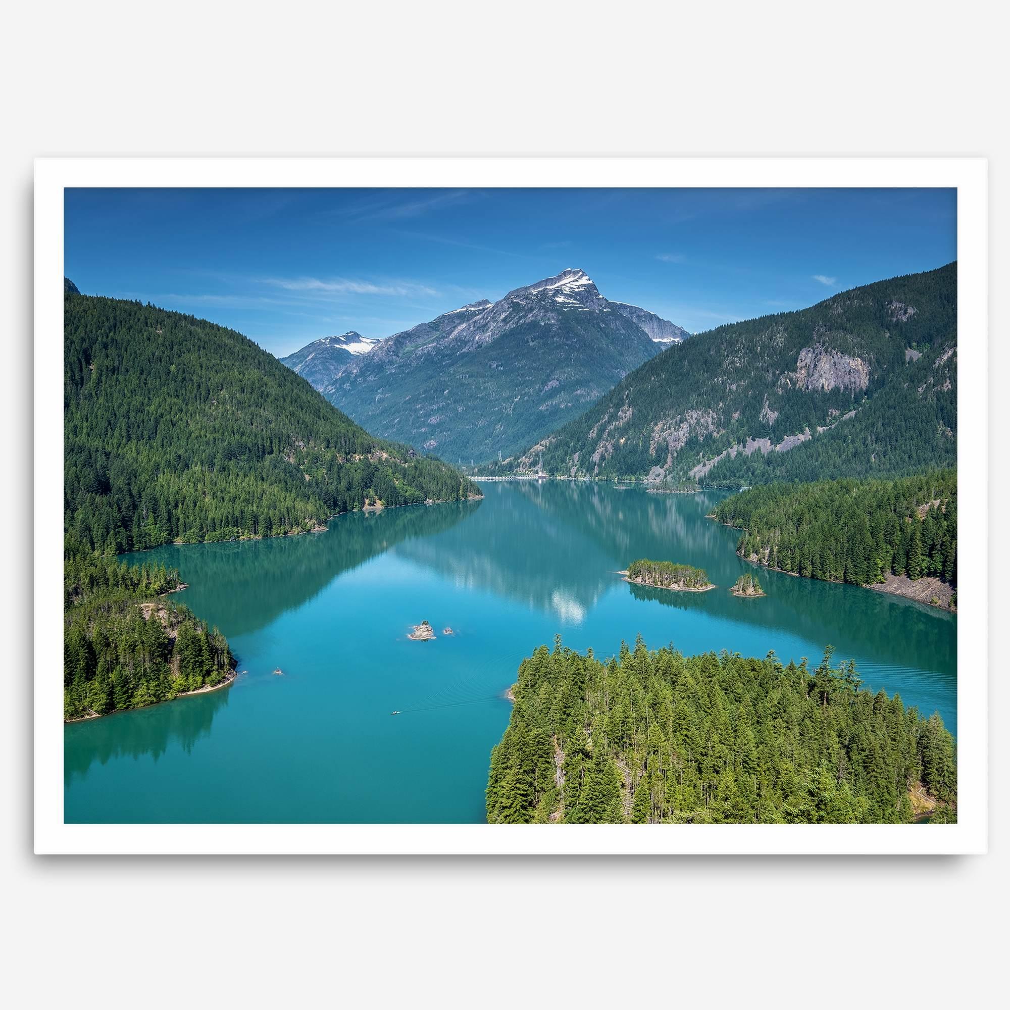 A fine art poster print of Diablo Lake in North Cascades National Park showcasing the deep blue water and the reflection of the surrounding mountains.