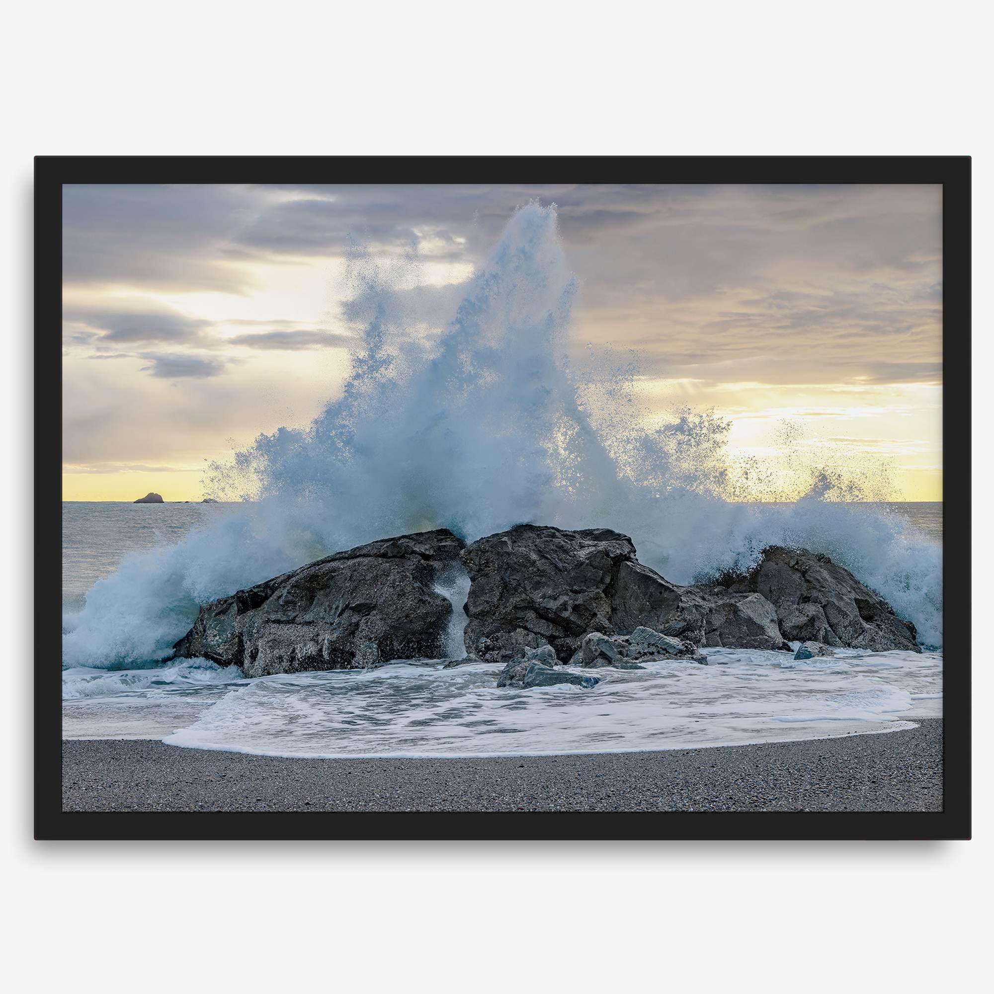 A dramatic fine art beach print showing a huge ocean wave crashing on a beautiful beach in California during sunset